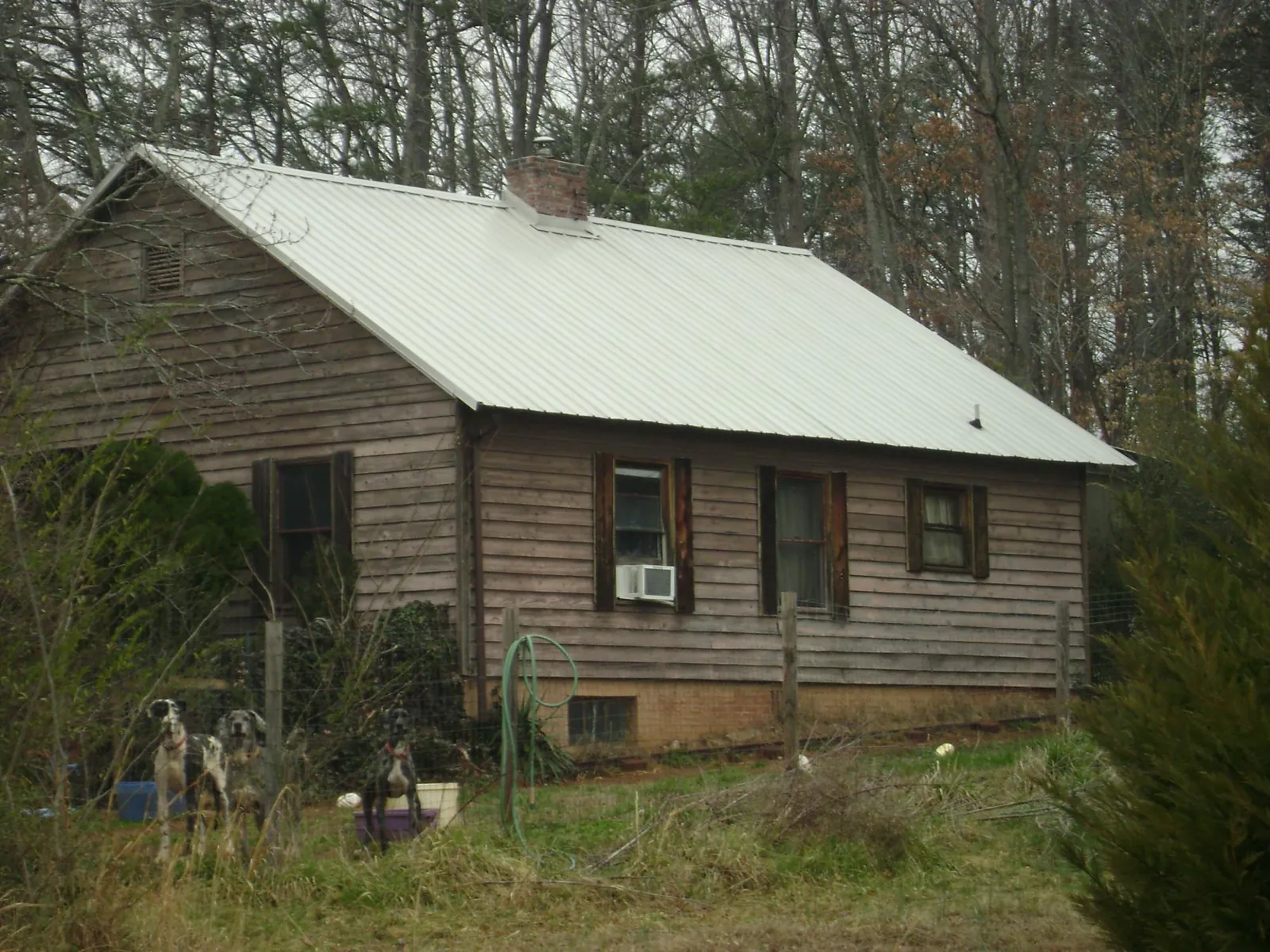 White metal roof on an old wood sided farmhouse, from a Metal Roof Installation job in La Rue